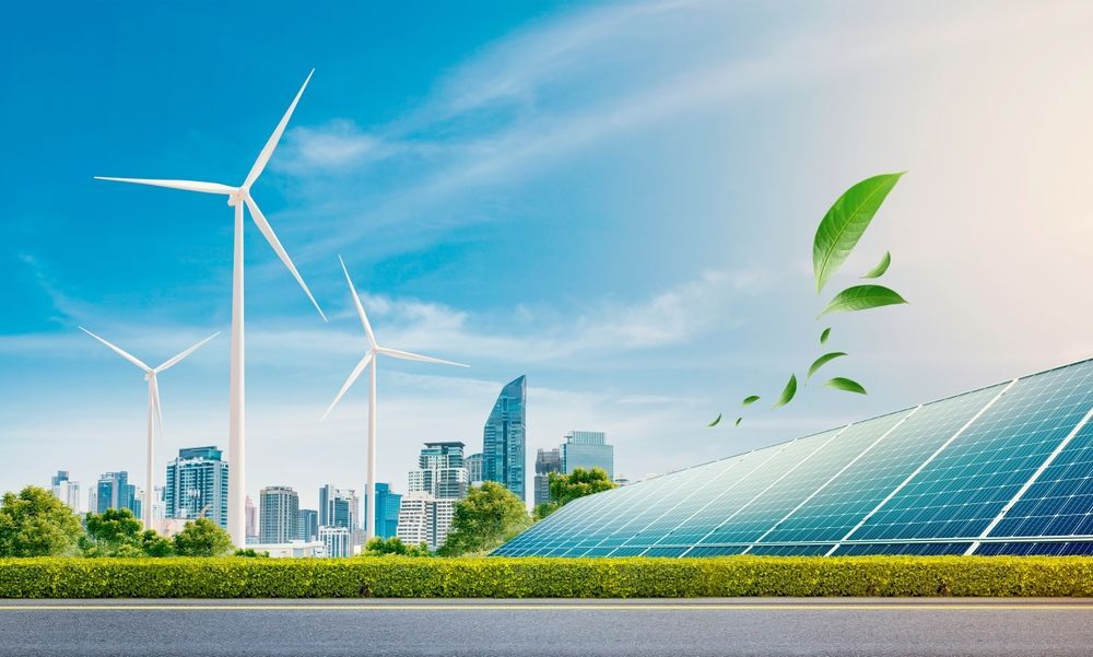 A city skyline with wind turbines and solar panels in the foreground.