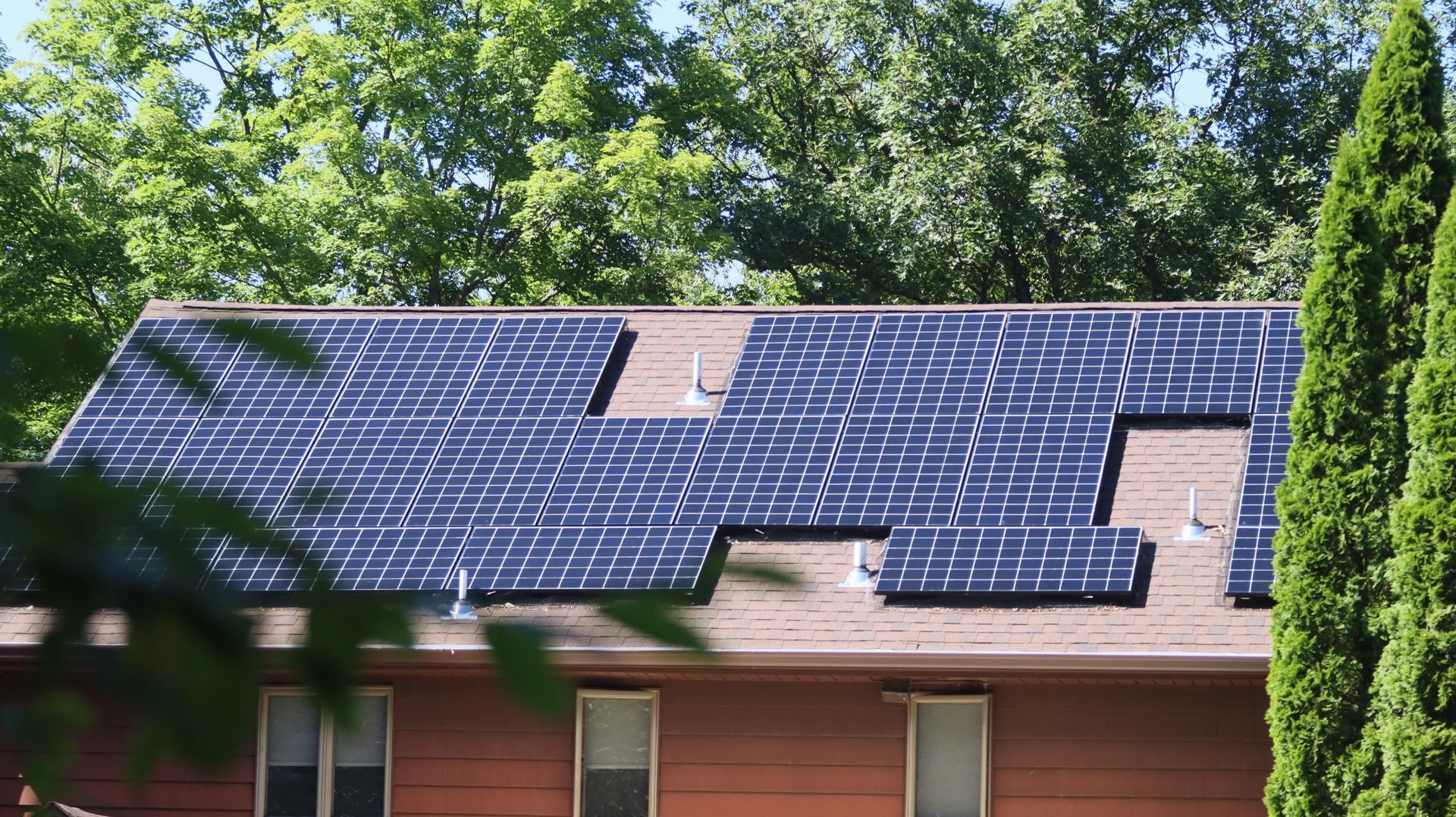 A house with a lot of solar panels on the roof