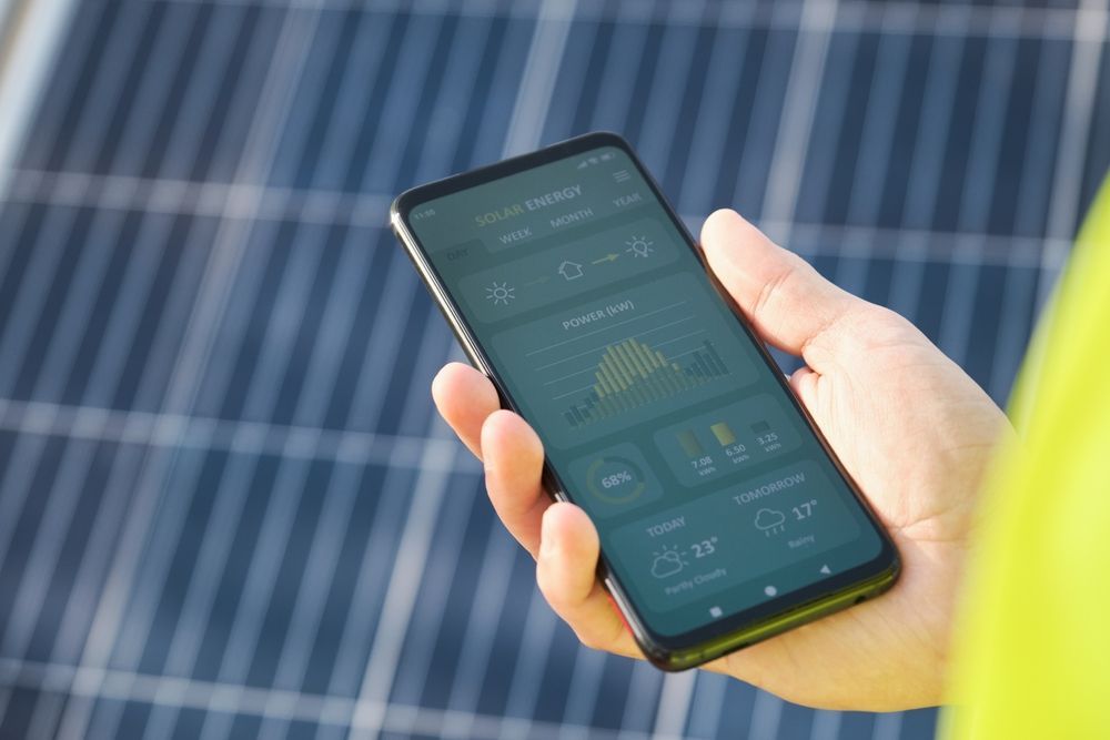 Two solar panels are sitting in front of a house.