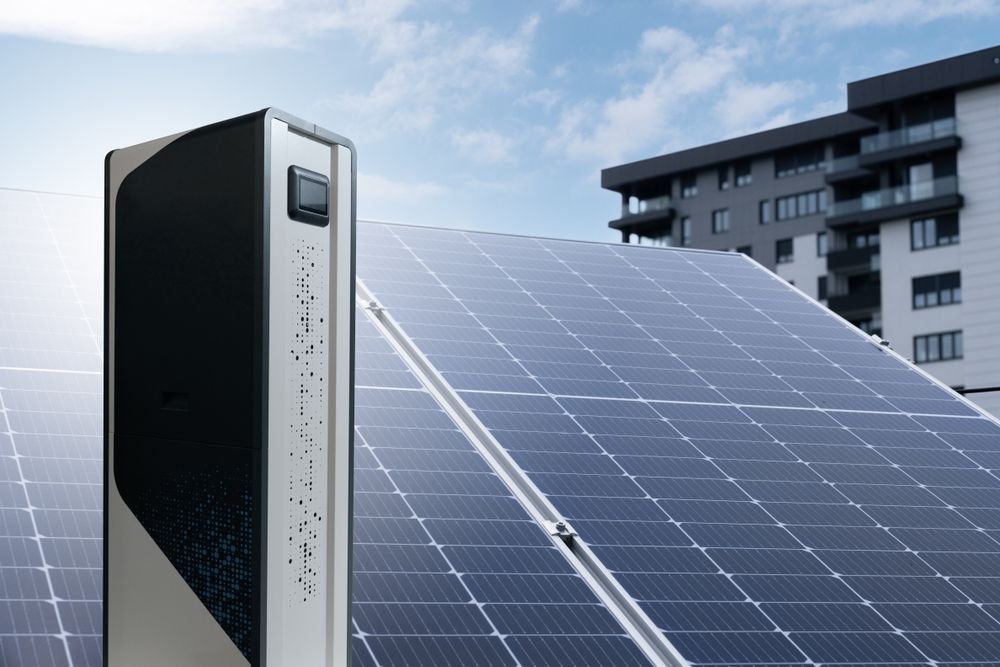 A row of solar panels with a building in the background