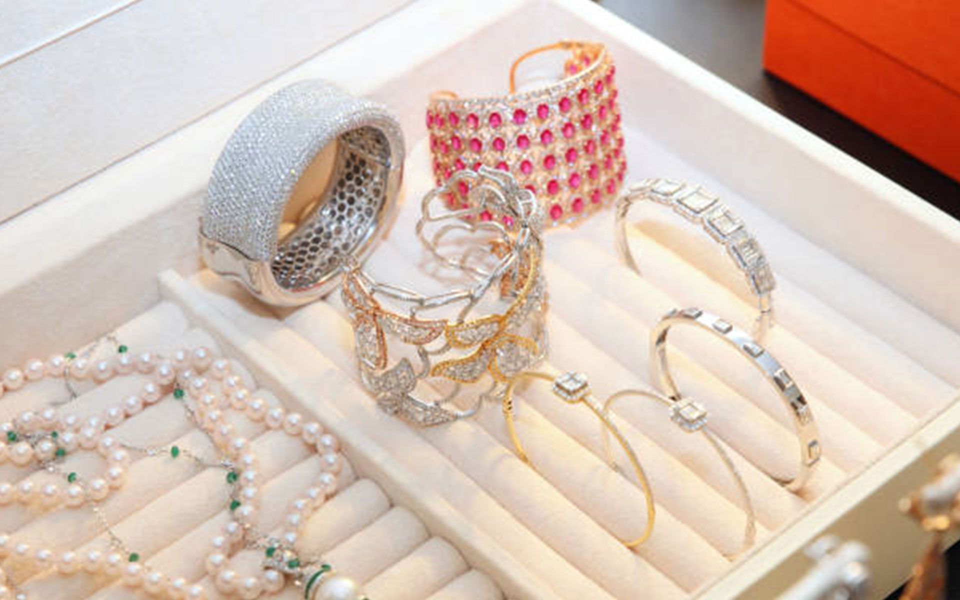 A jewelry box filled with bracelets , necklaces , and rings.