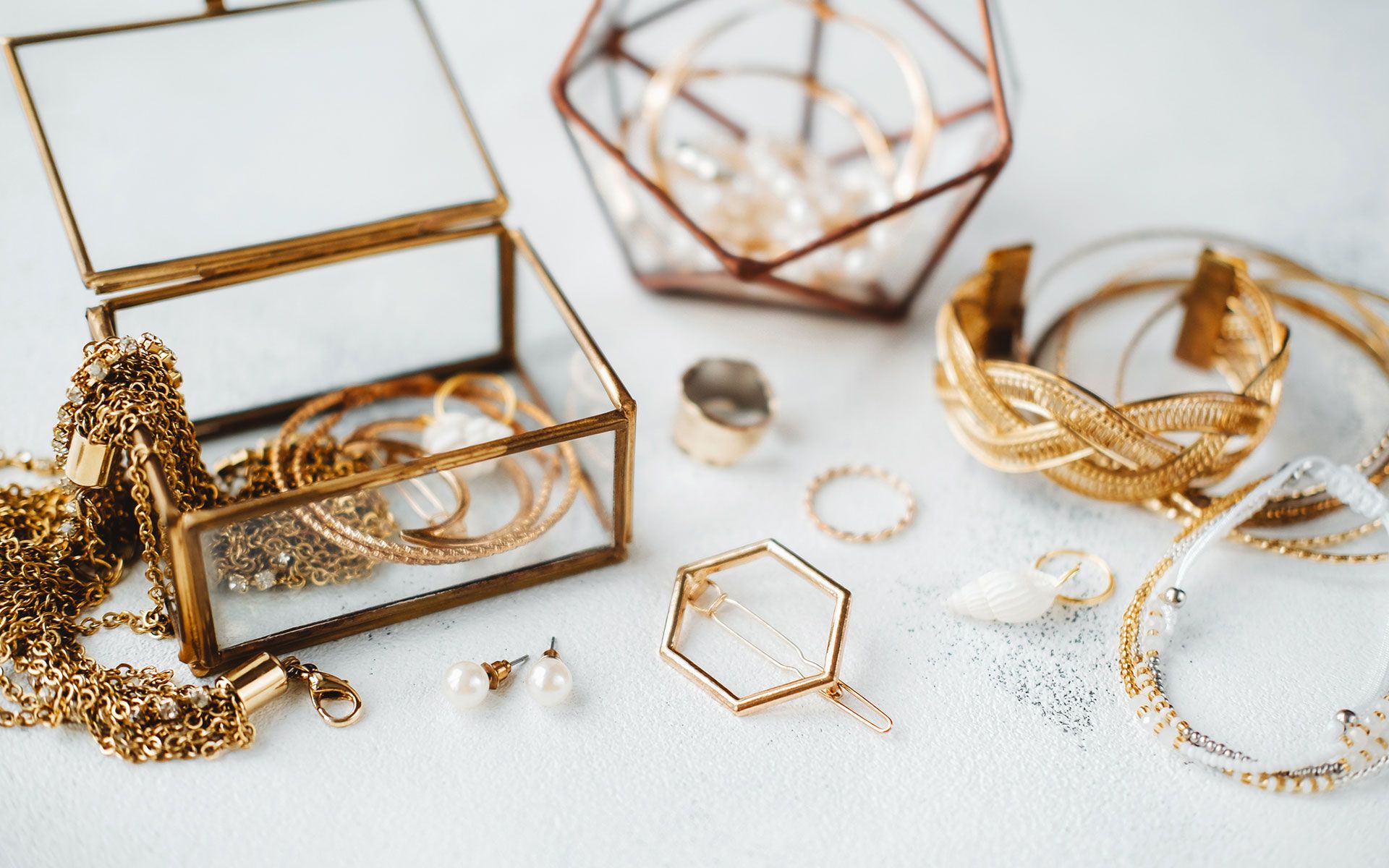 There are many different types of gold jewelry on the table.