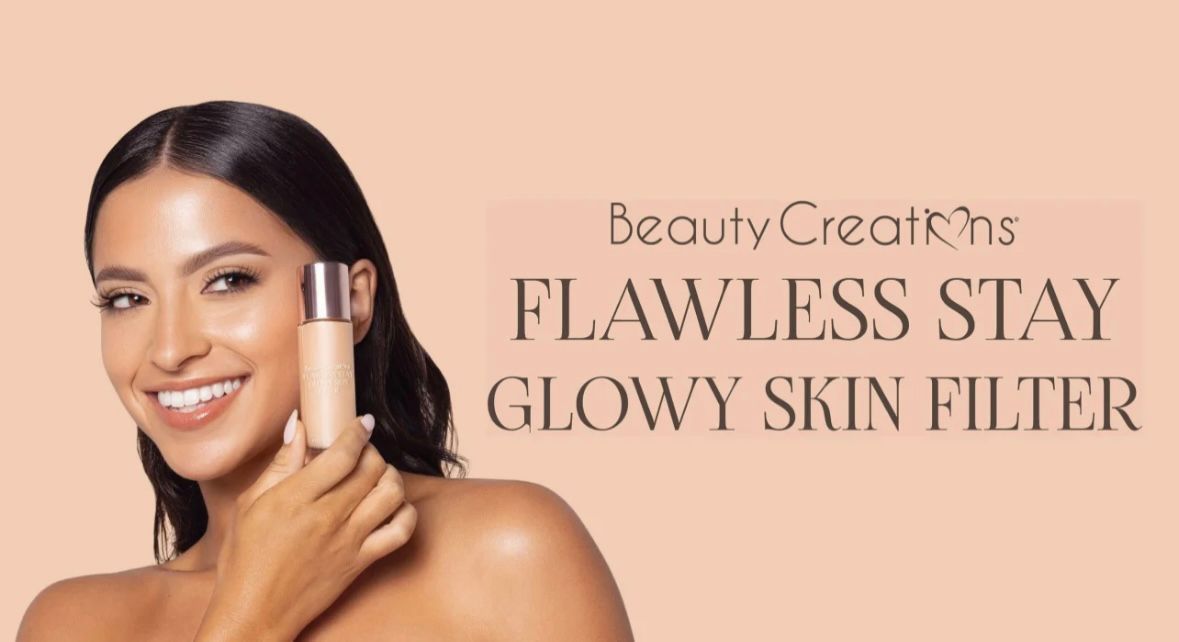 A set of makeup brushes in pink containers on a pink background.