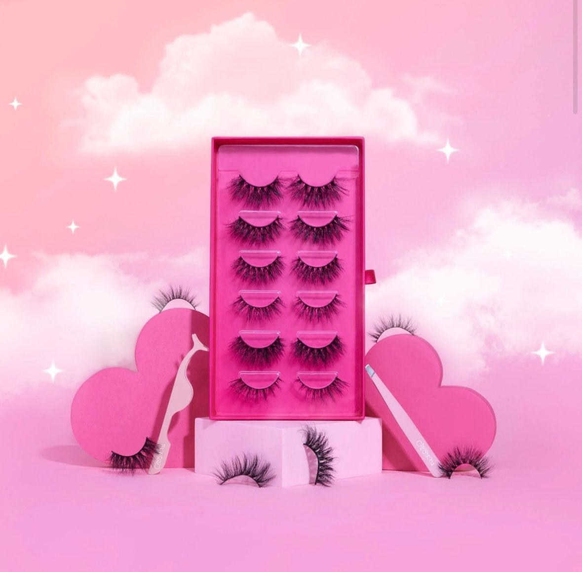 A stack of fake eyelashes sitting on top of each other on a white surface.