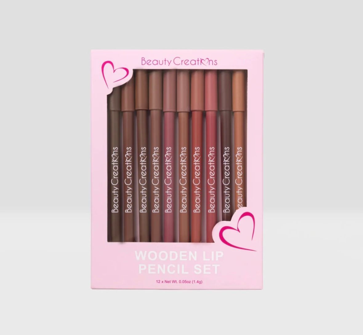 There are many different types of cosmetics on a pink background.