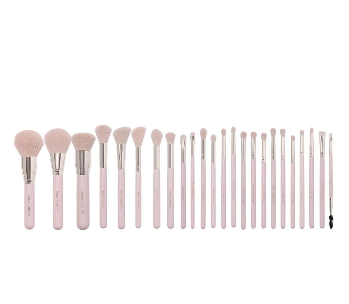 A set of pink makeup brushes are lined up in a row on a white background.