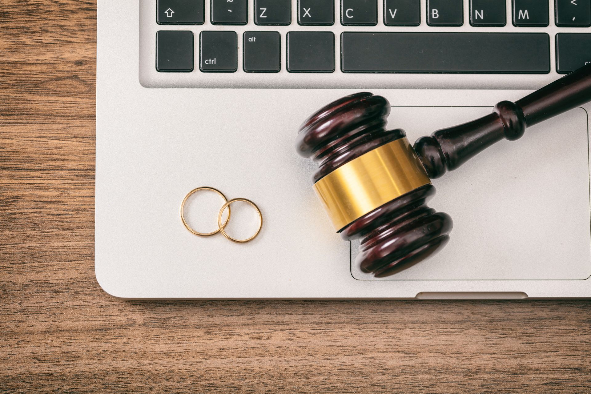A Judge's Gavel and Wedding Rings Are on a Laptop | Sydney, NSW | Online Divorce Australia