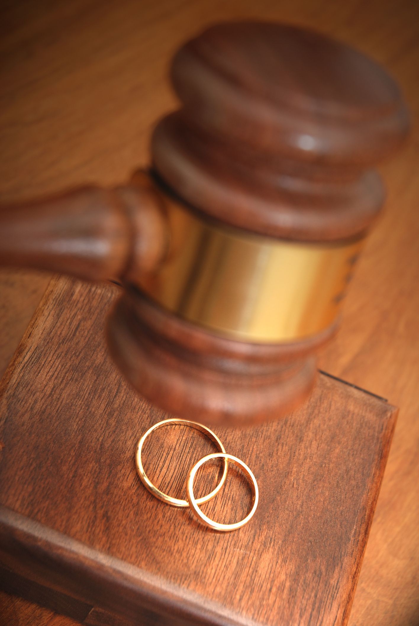 A Pair of Wedding Rings Sitting on Top of a Wooden Gavel | Sydney, NSW | Online Divorce Australia