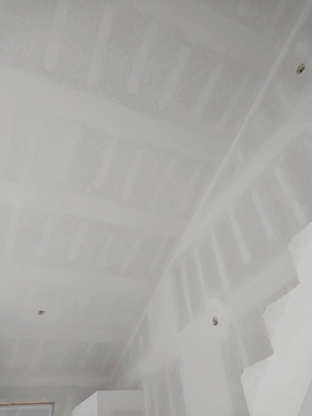 A room with a staircase and a white ceiling.