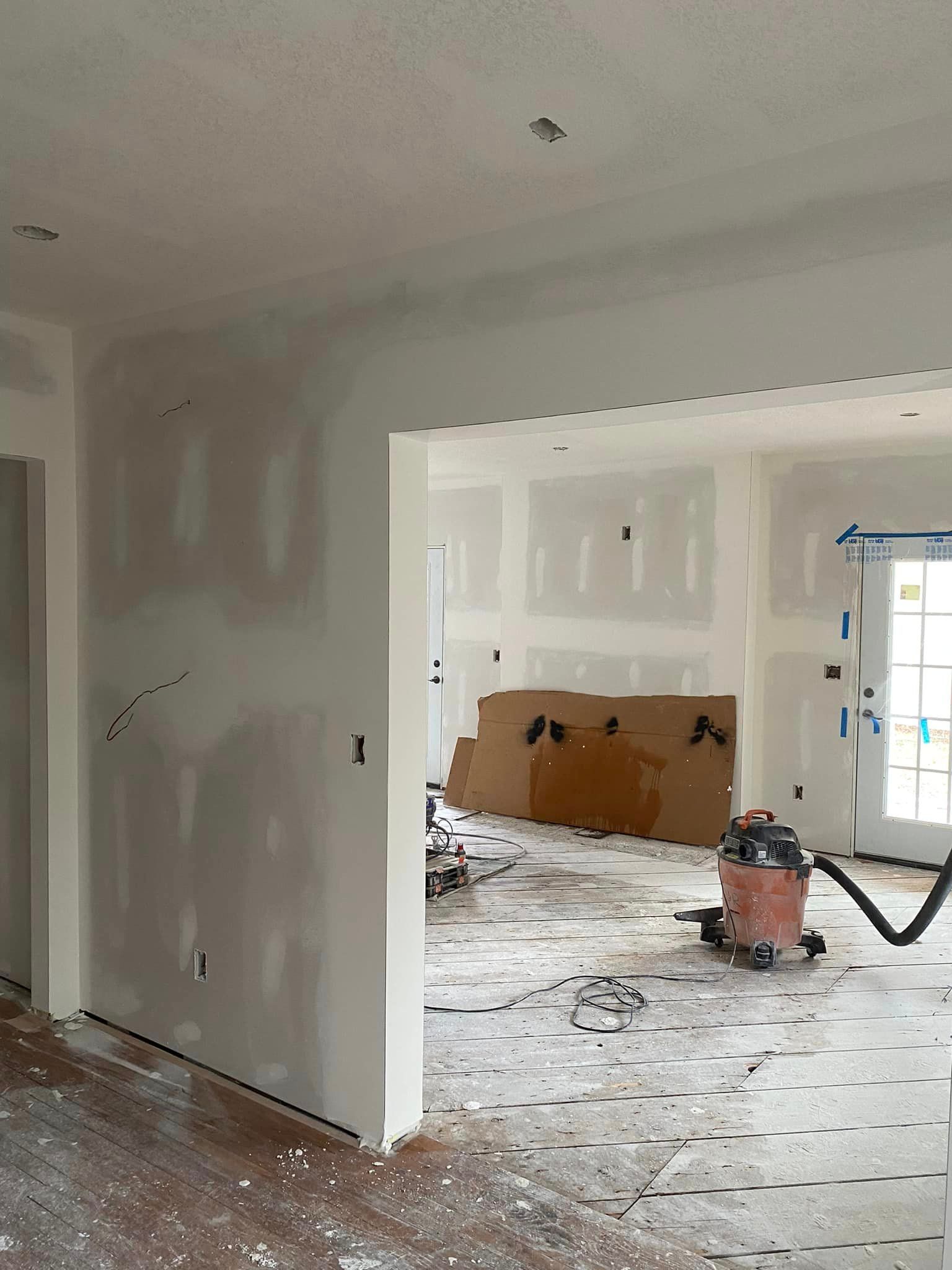 There is a vacuum cleaner in the middle of the room.