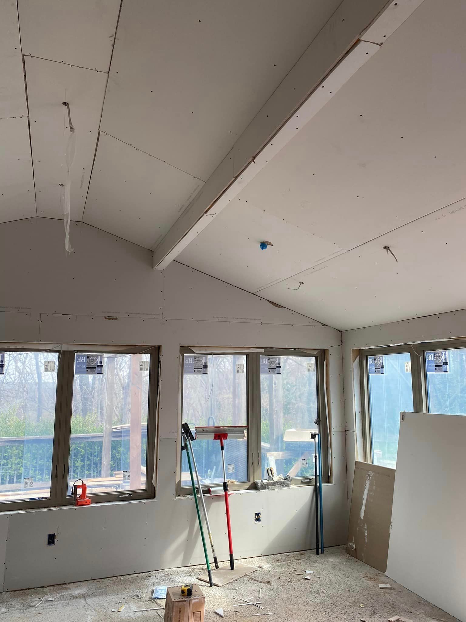 A room with a vaulted ceiling and lots of windows