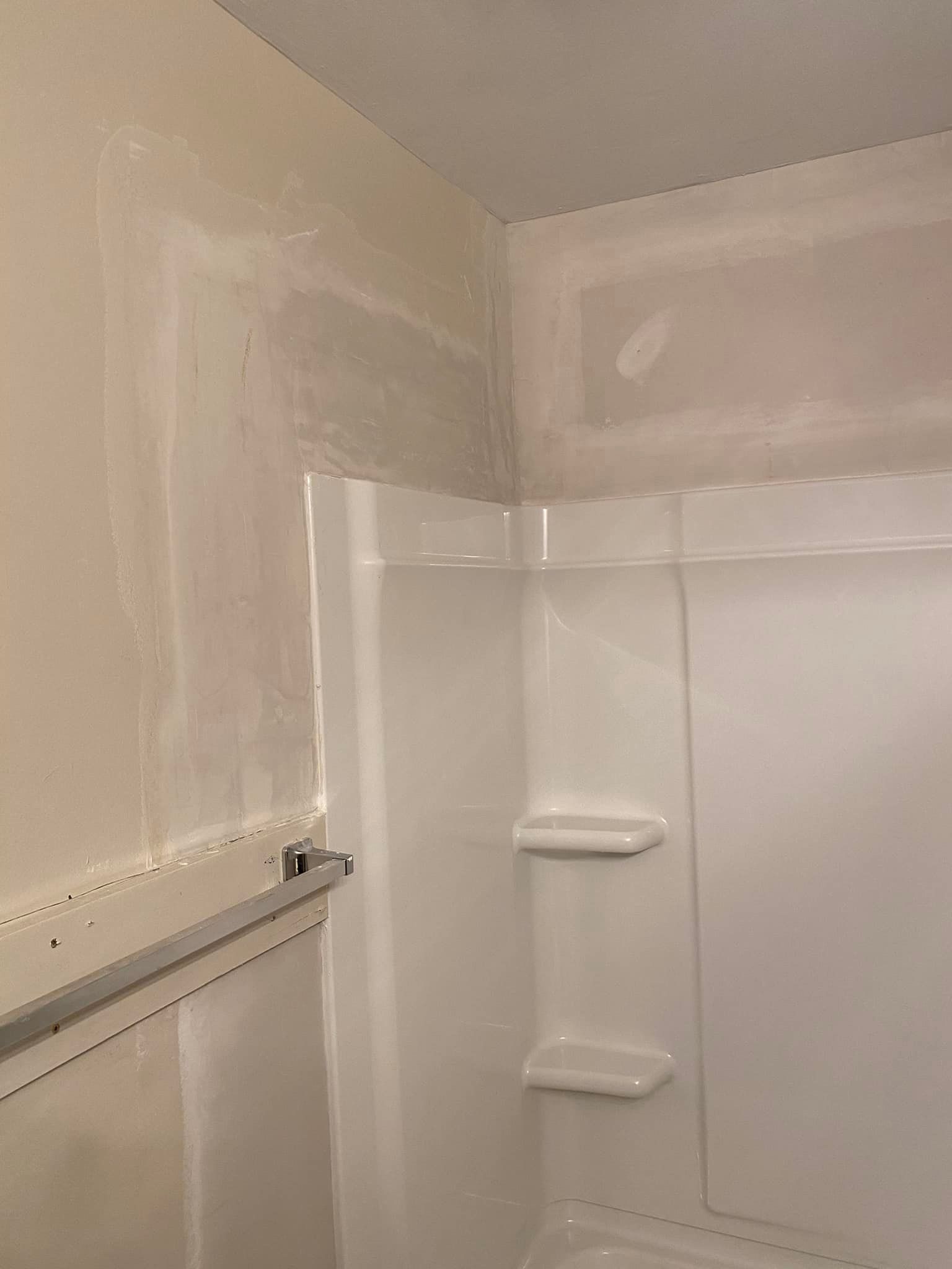 A bathroom with a shower stall and a bathtub.