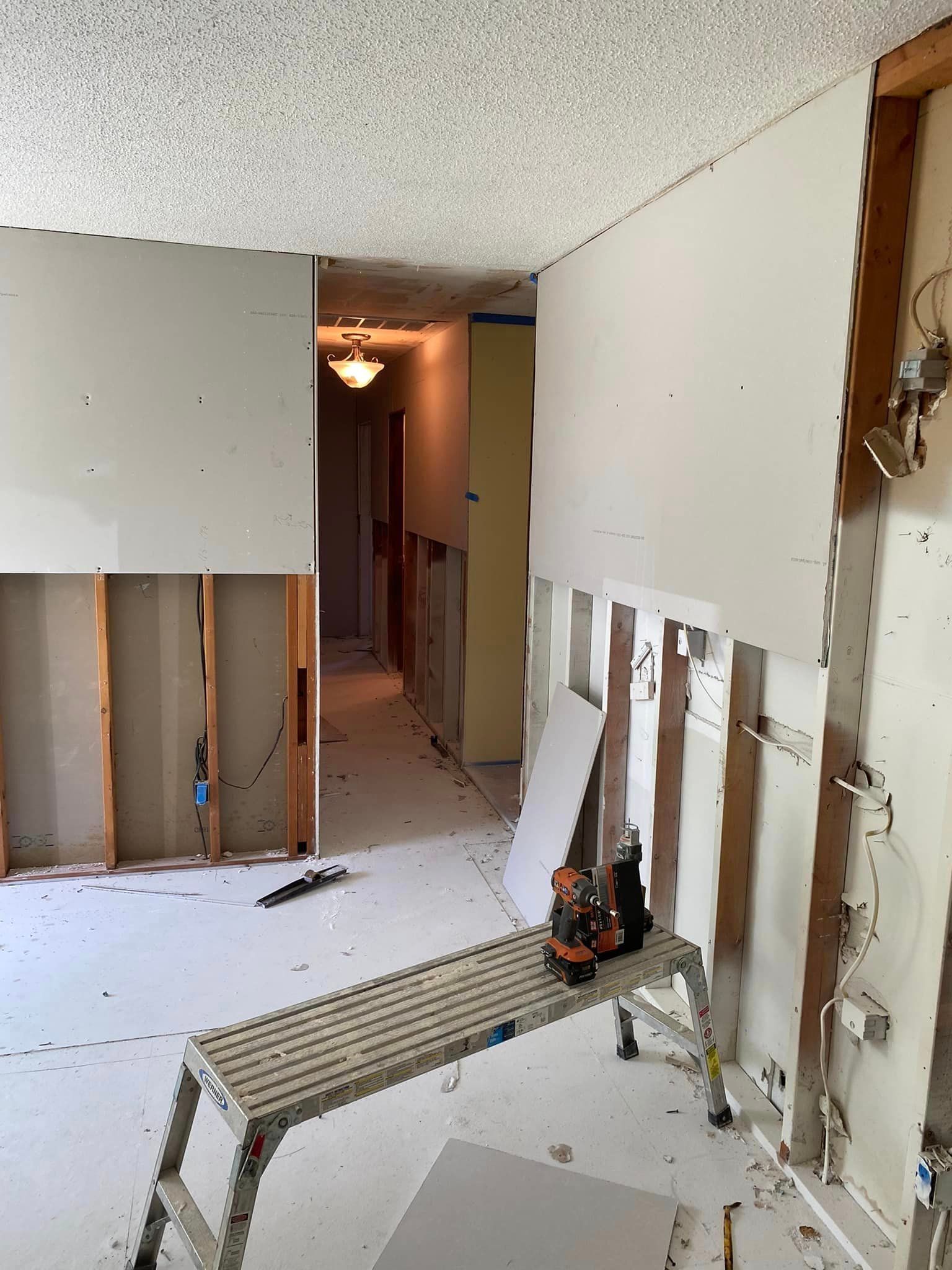 A room with a ladder and a bench in it.