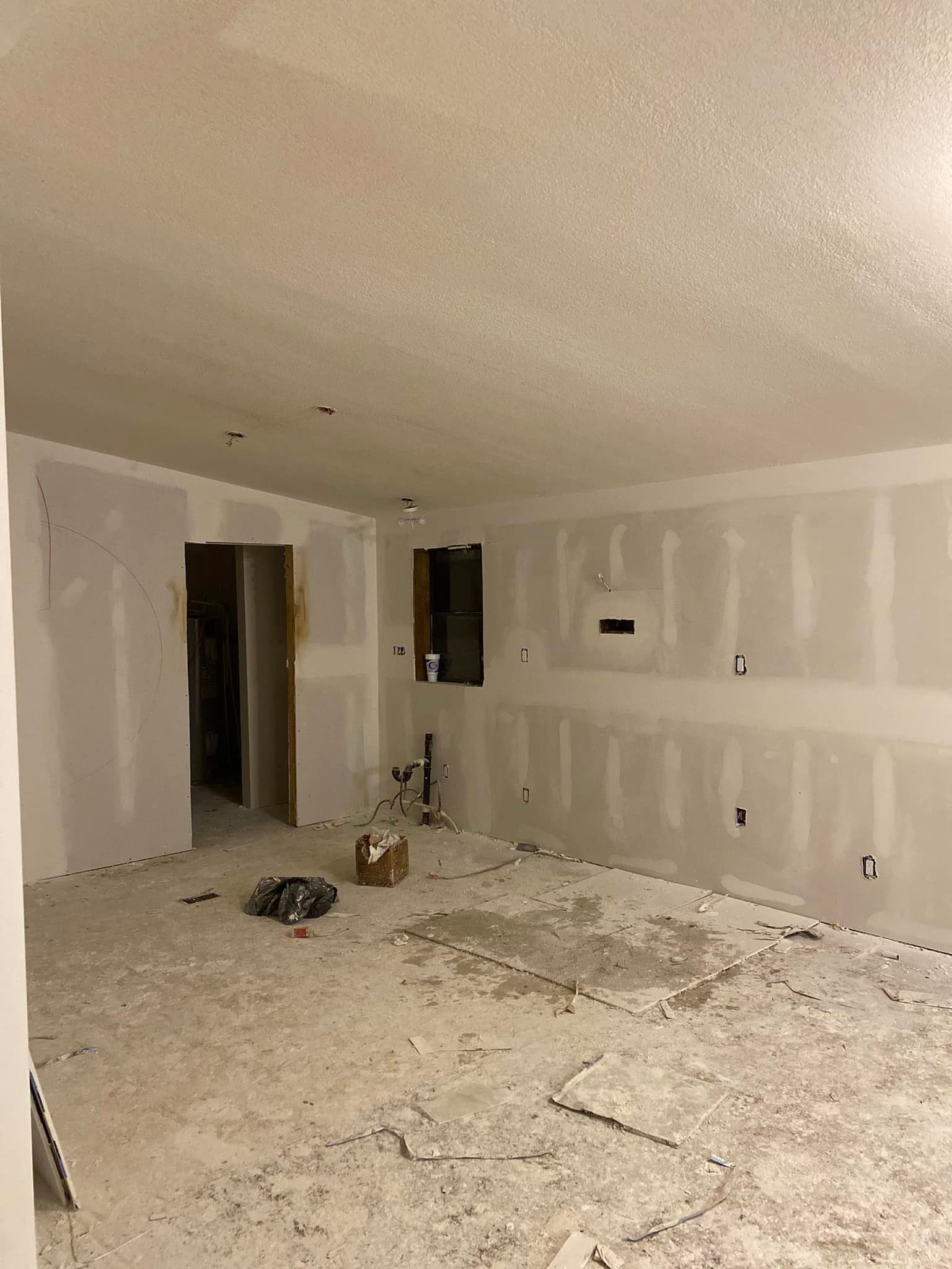 A room with drywall on the walls and a box on the floor.