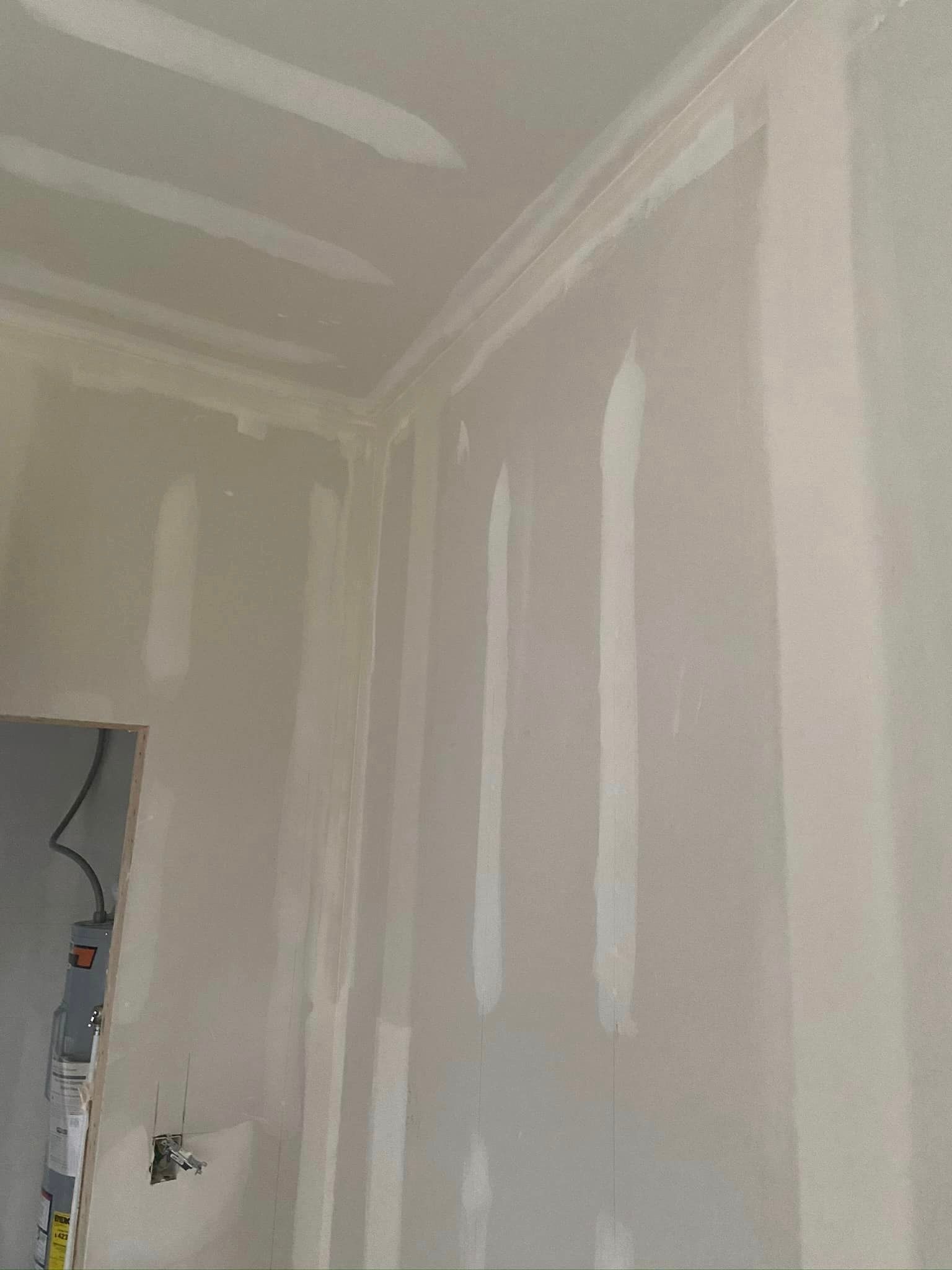 A room with drywall walls and a ceiling.