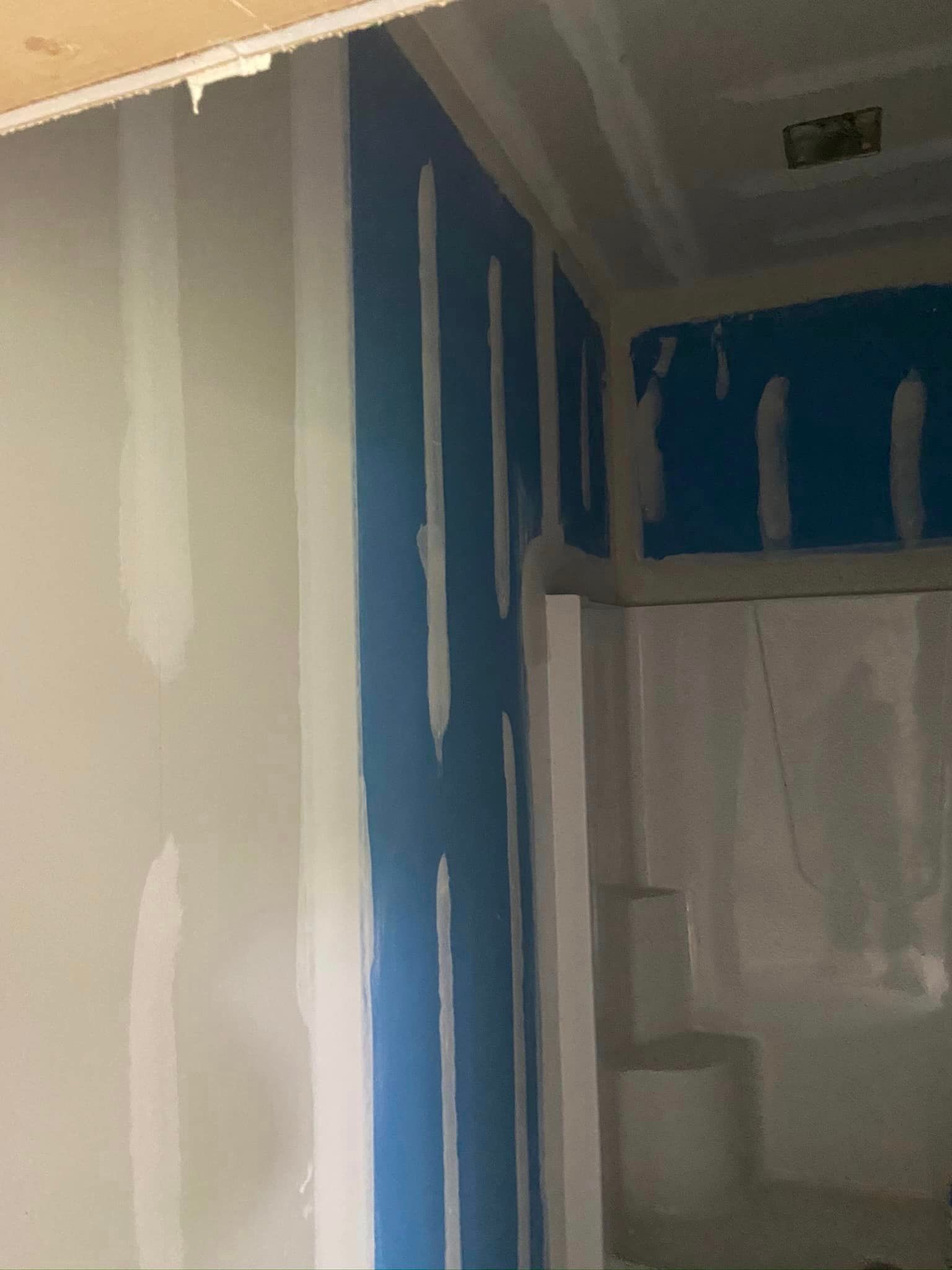 A room with a blue wall and a white wall.