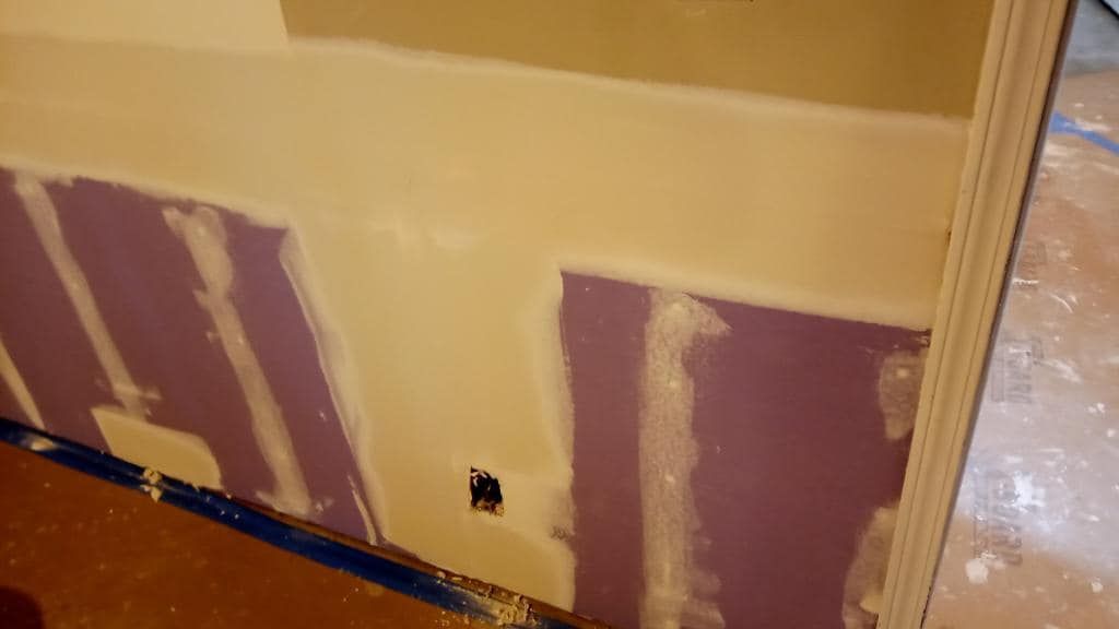 A close up of a wall with a hole in it.