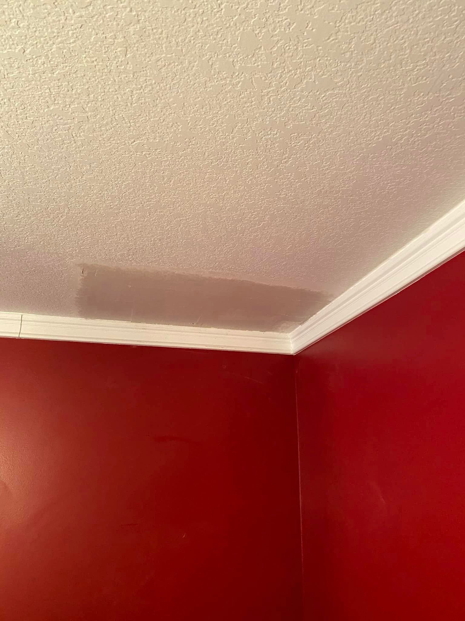 A room with red walls and a white ceiling.