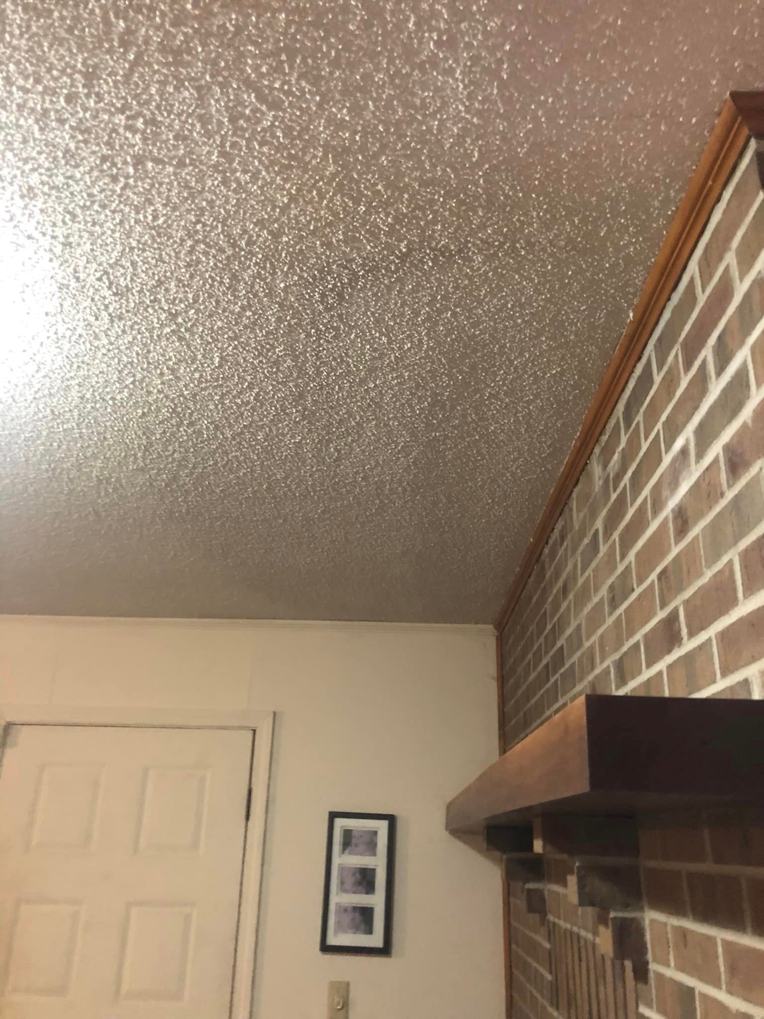A living room with a brick wall and a ceiling with glitter.