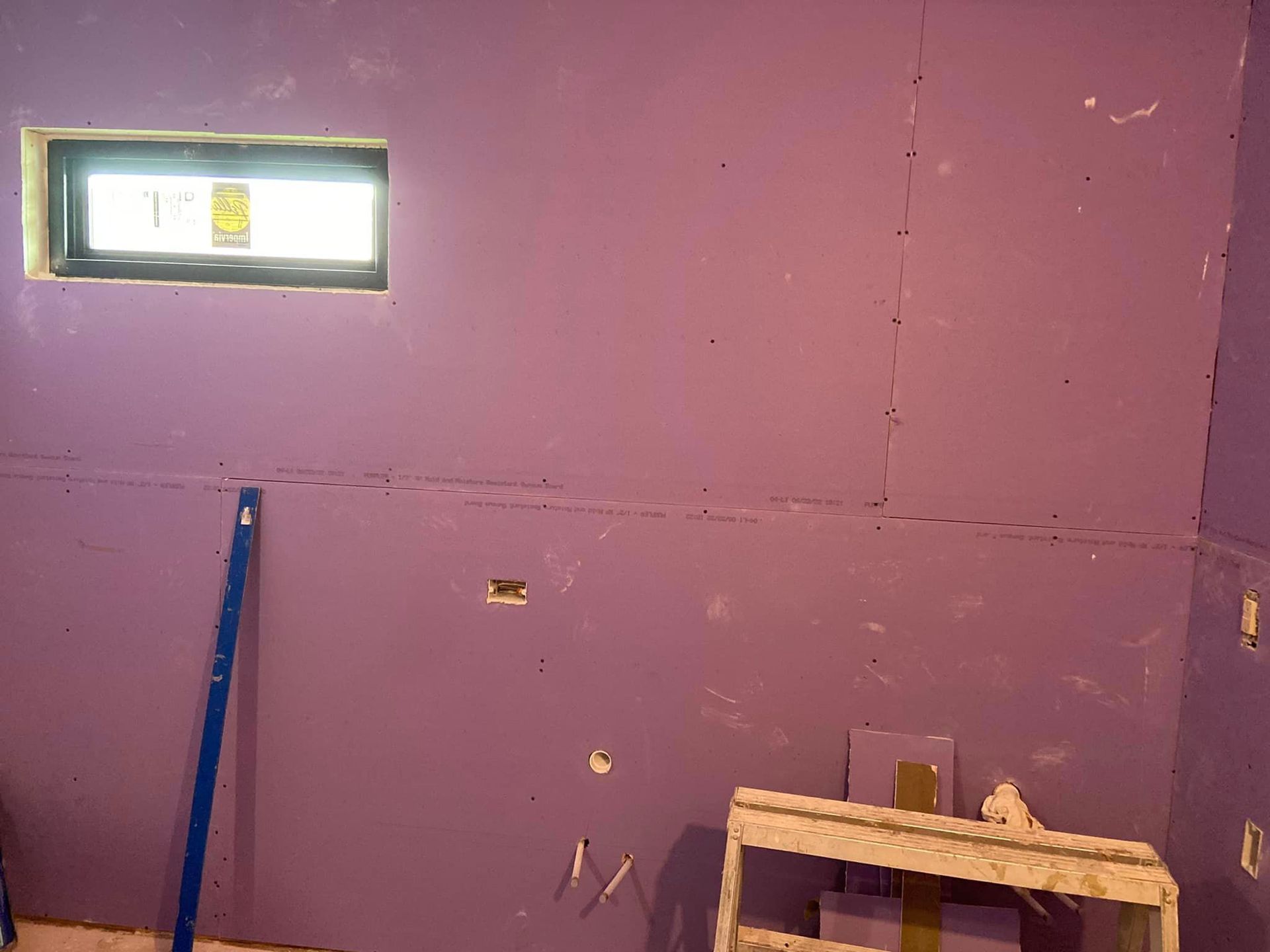 A room with purple walls and a window.