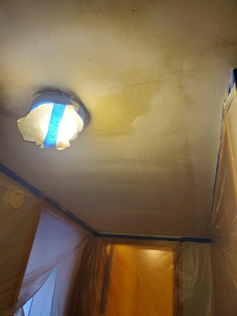 A light is hanging from the ceiling of a room.