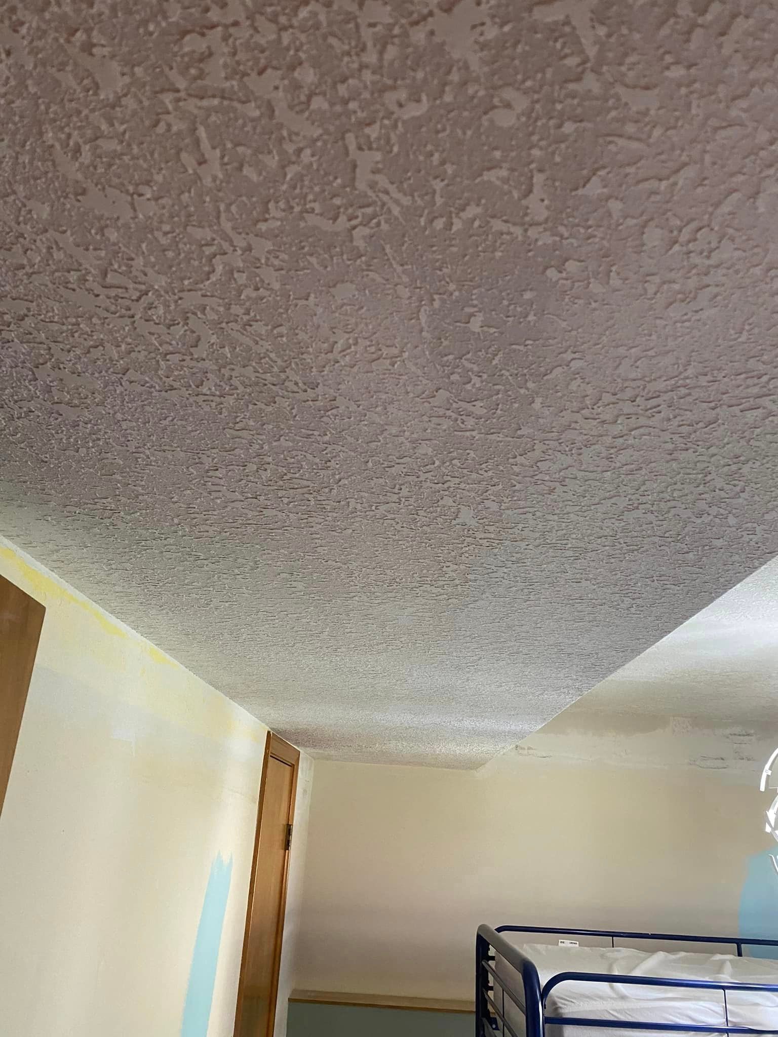A bedroom with a bunk bed and a ceiling that is upside down.
