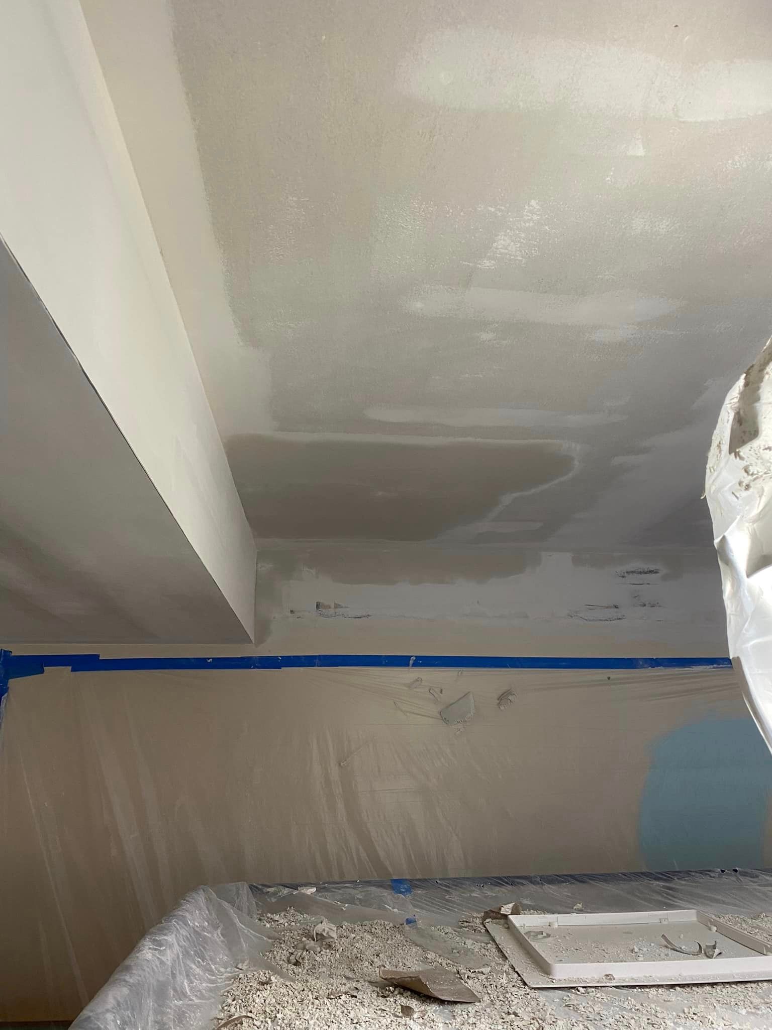 A person is painting a ceiling in a room.