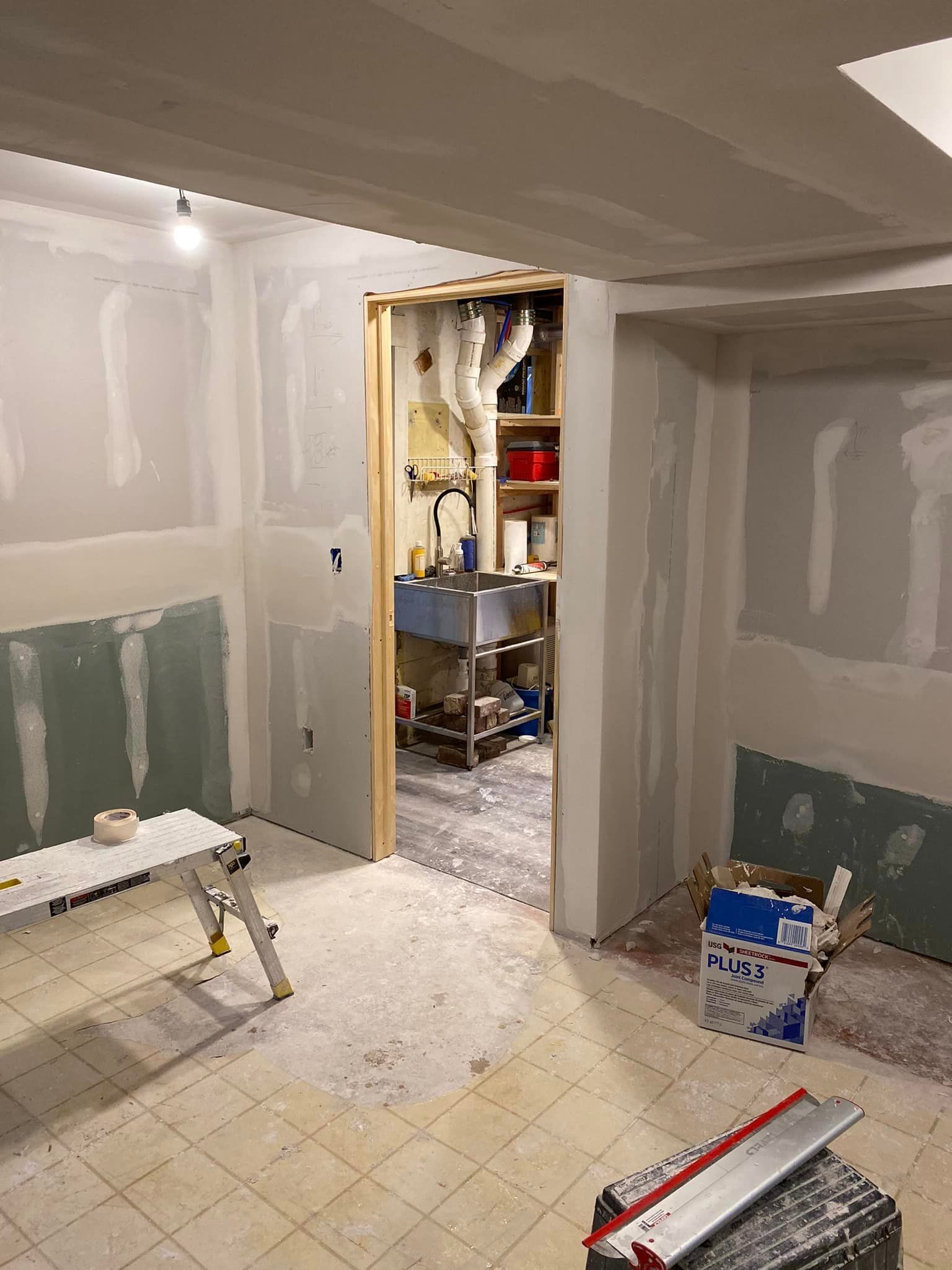 A room with a table and a box in it is being remodeled.