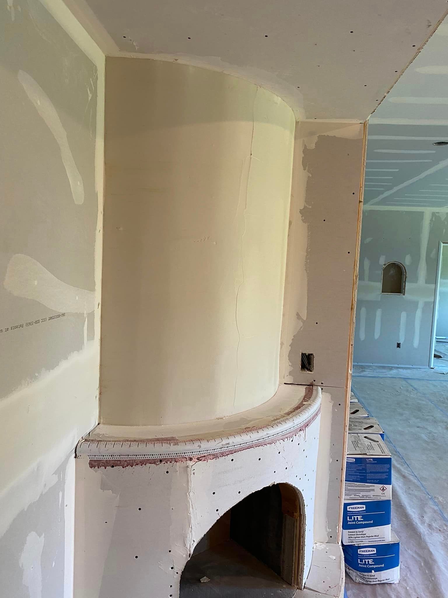 A fireplace in a room that is being remodeled