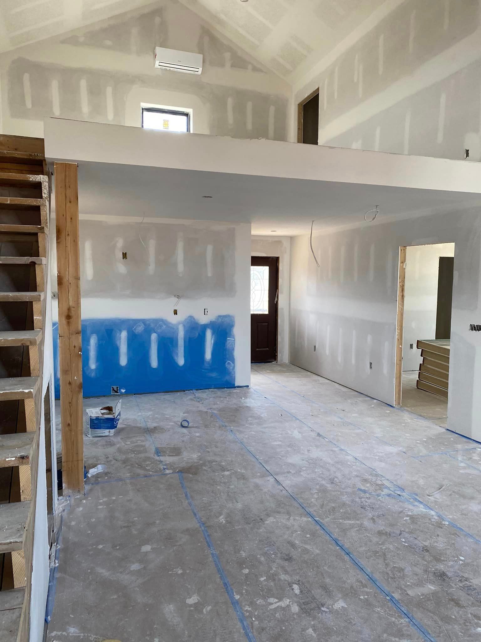 An empty room with a staircase leading to the second floor