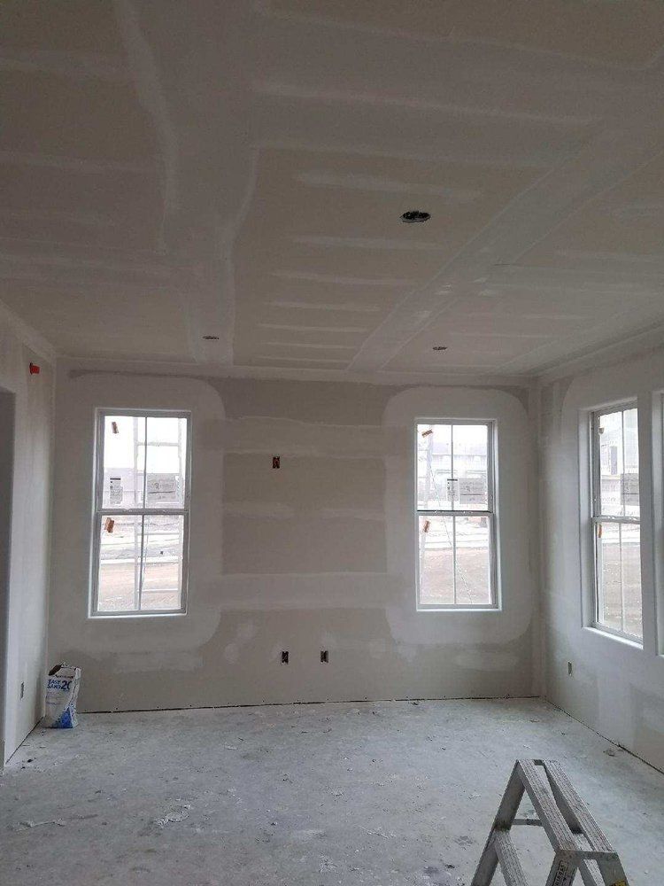 A room with a lot of windows and a ladder in it.