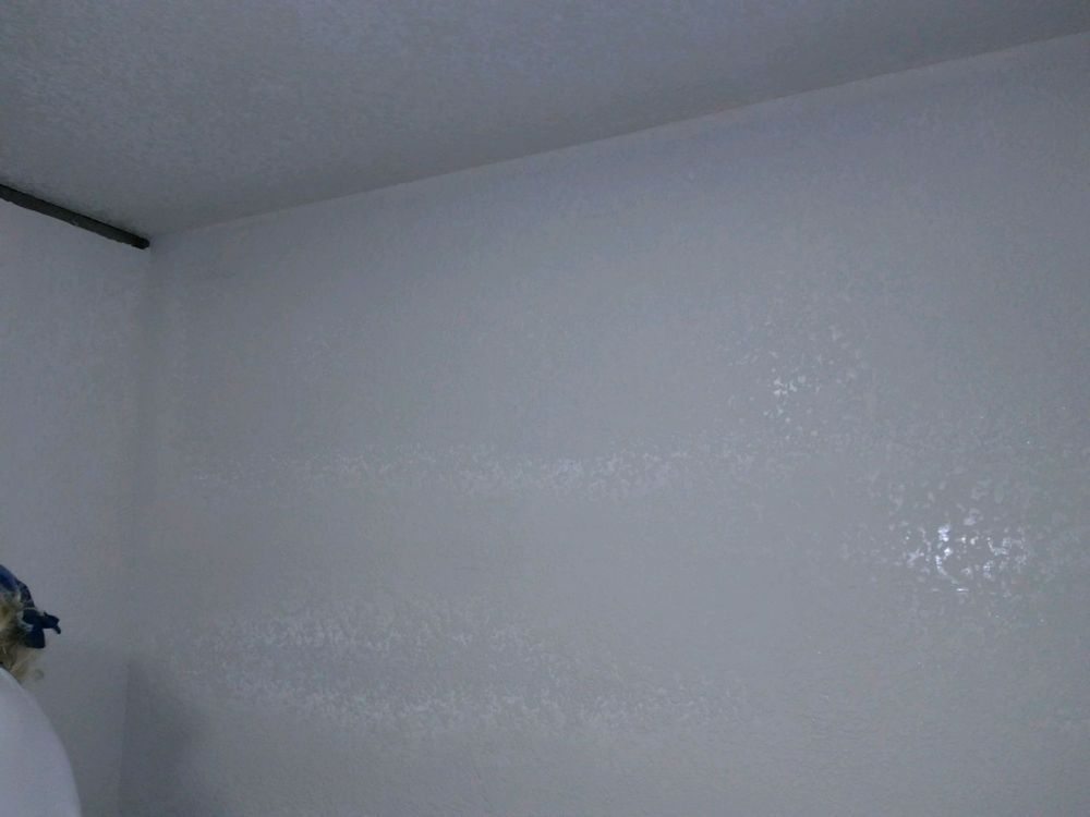 A close up of a white wall in a bathroom.