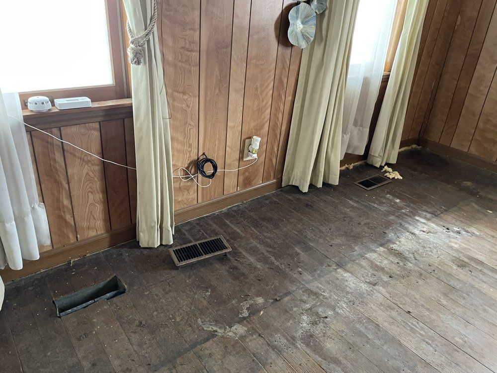 A room with wood paneling and a wooden floor.