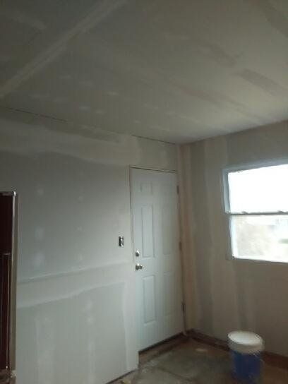 A room with a door and a window in it.