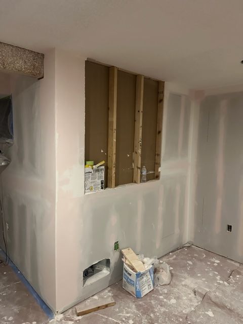 A room with drywall walls and a box on the floor.