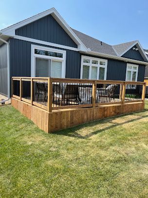 A house with a wooden deck in front of it.