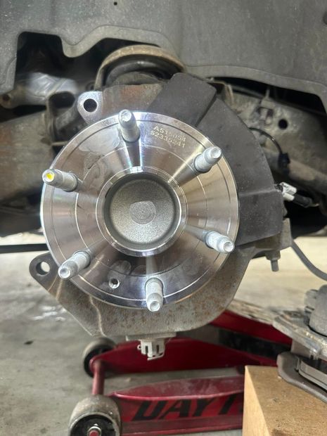 A close up of a brake disc on a car.