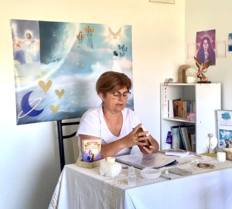 Hands reaching up toward doves flying in a golden sunset.