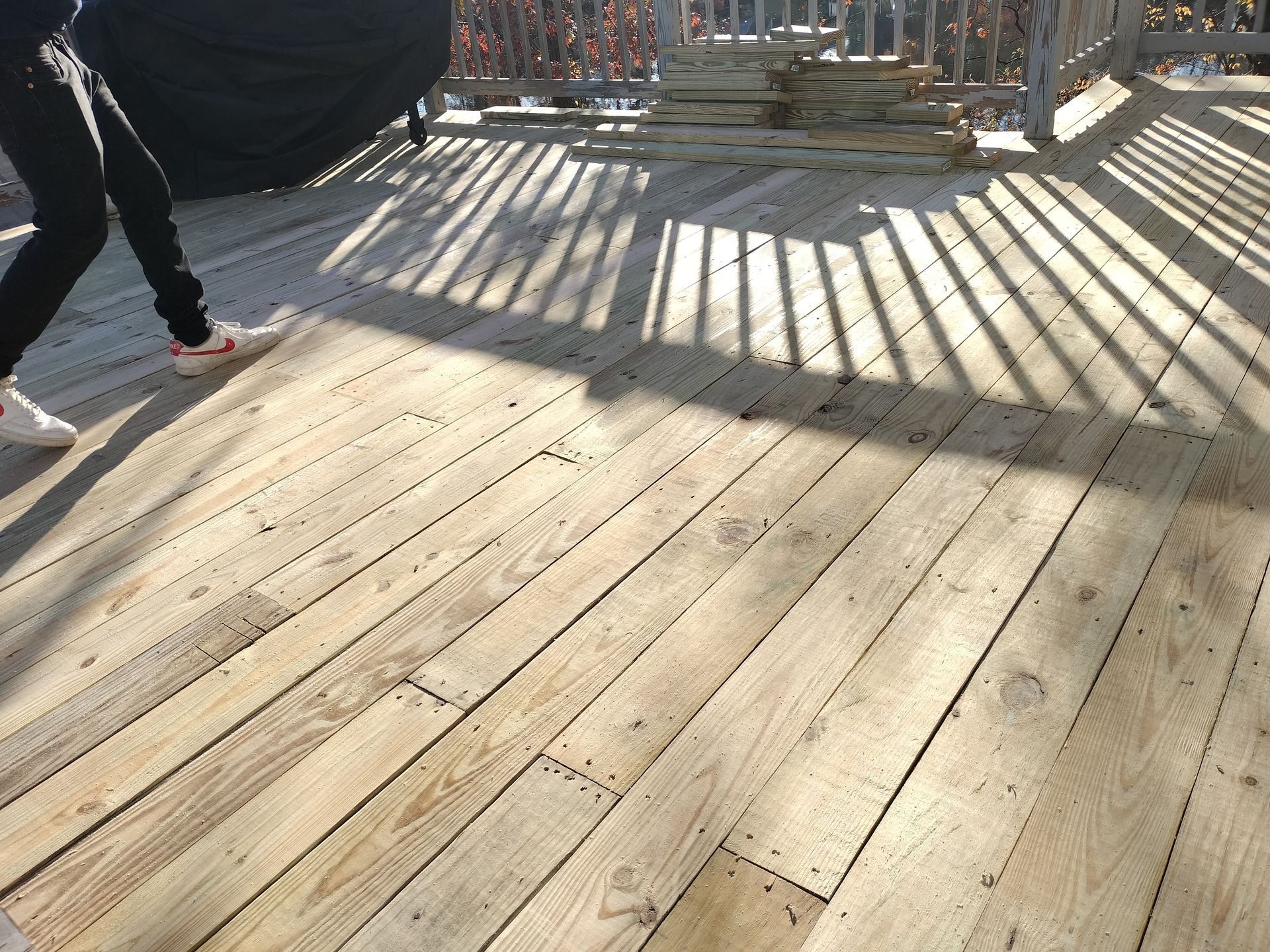 A wooden deck with a person walking on it