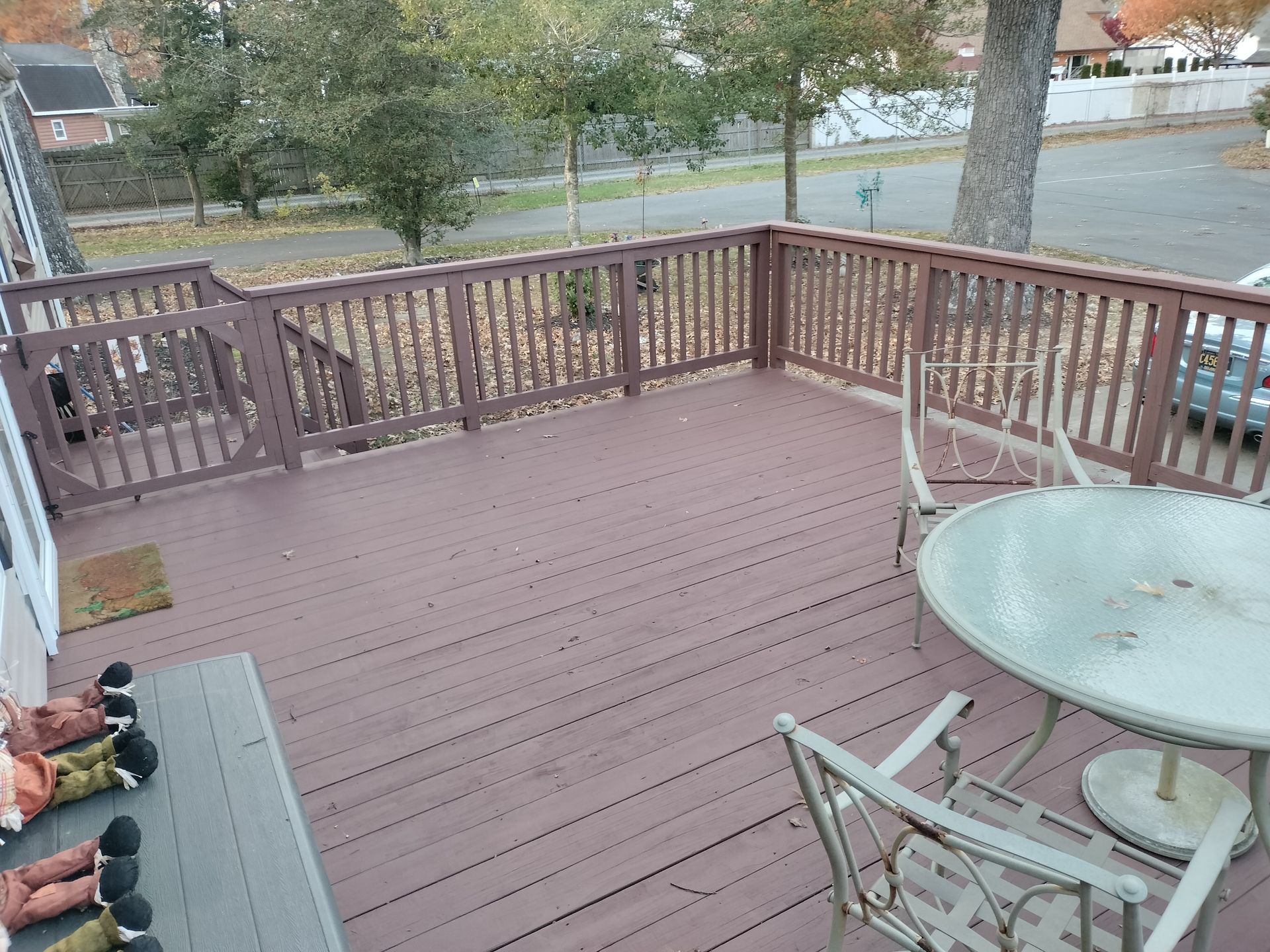 A wooden deck with a table and chairs on it