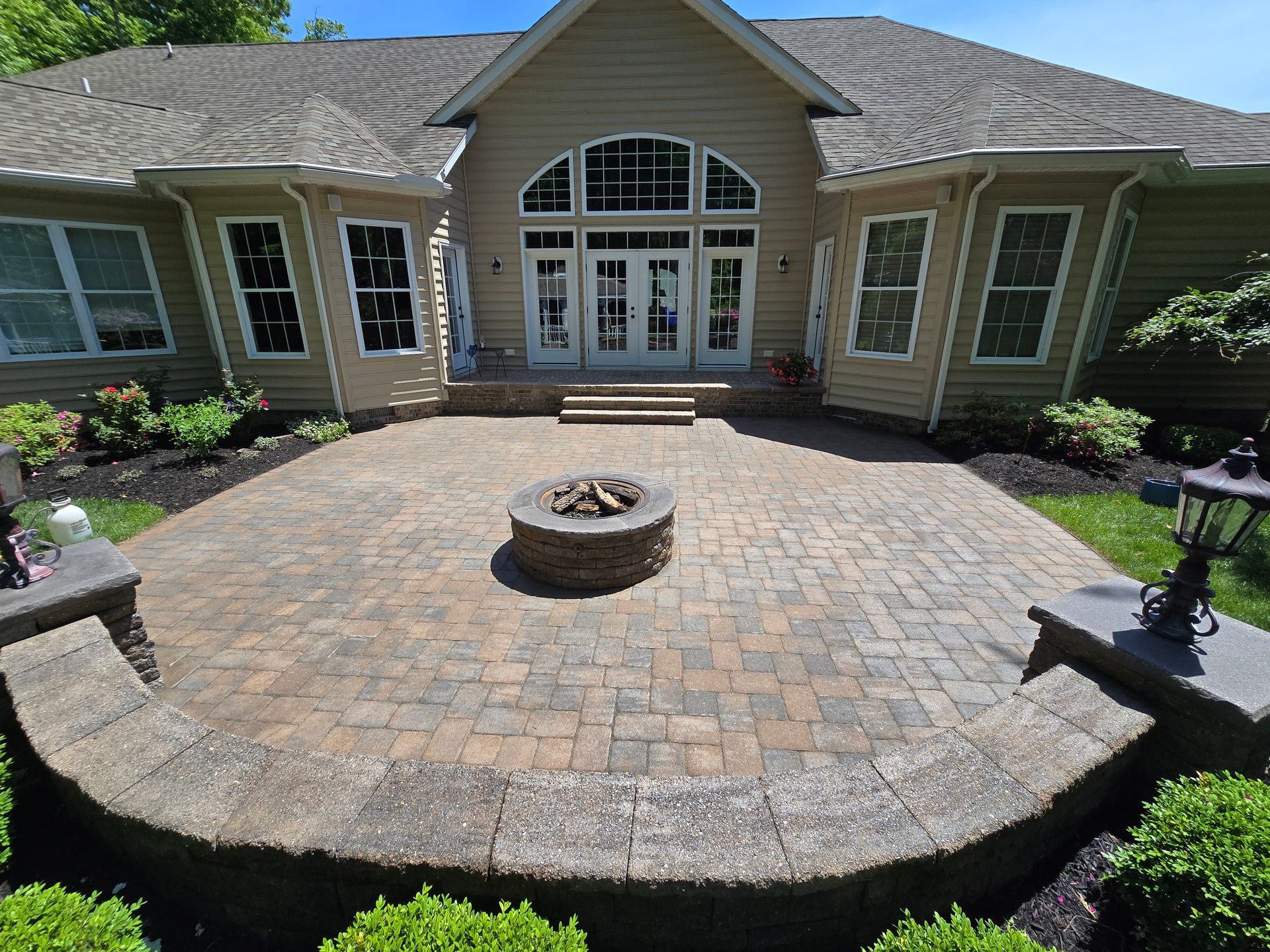 A large house with a fire pit in front of it.