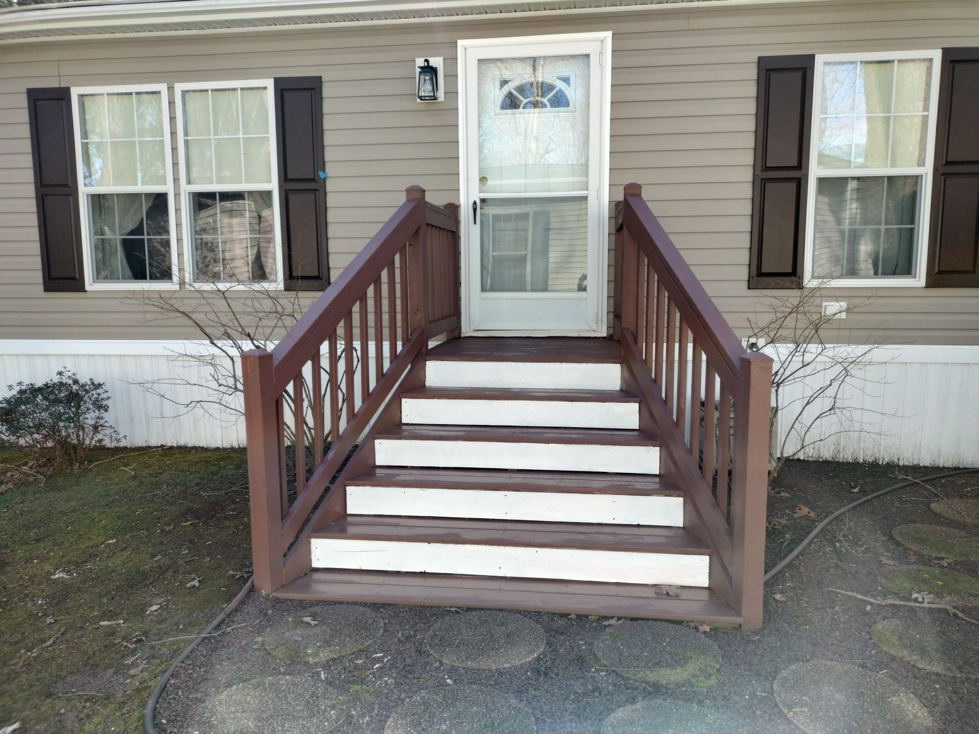 A house with stairs leading up to the front door