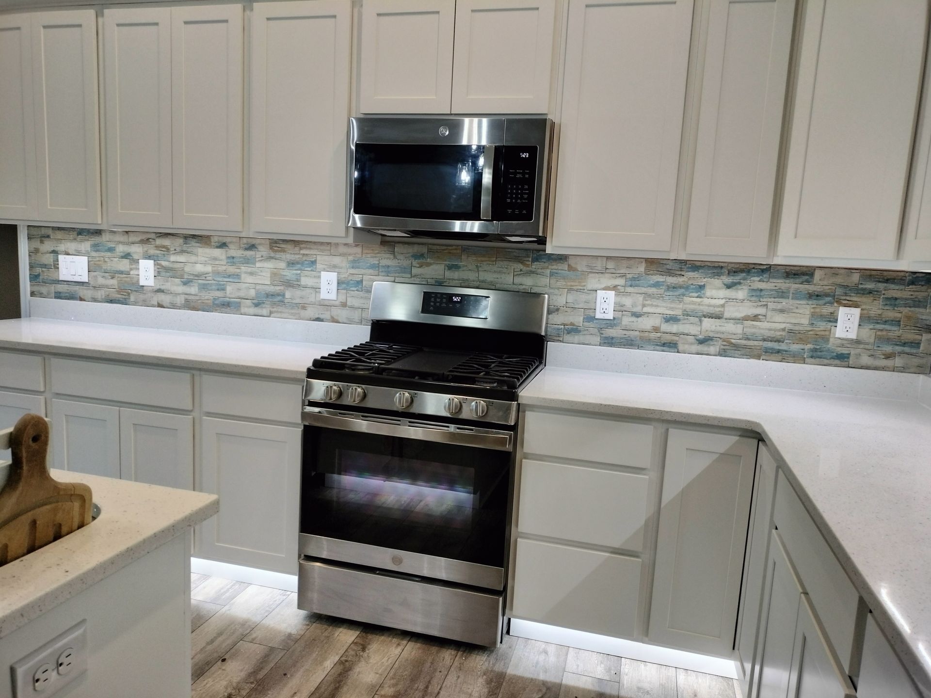 A kitchen with stainless steel appliances and white cabinets