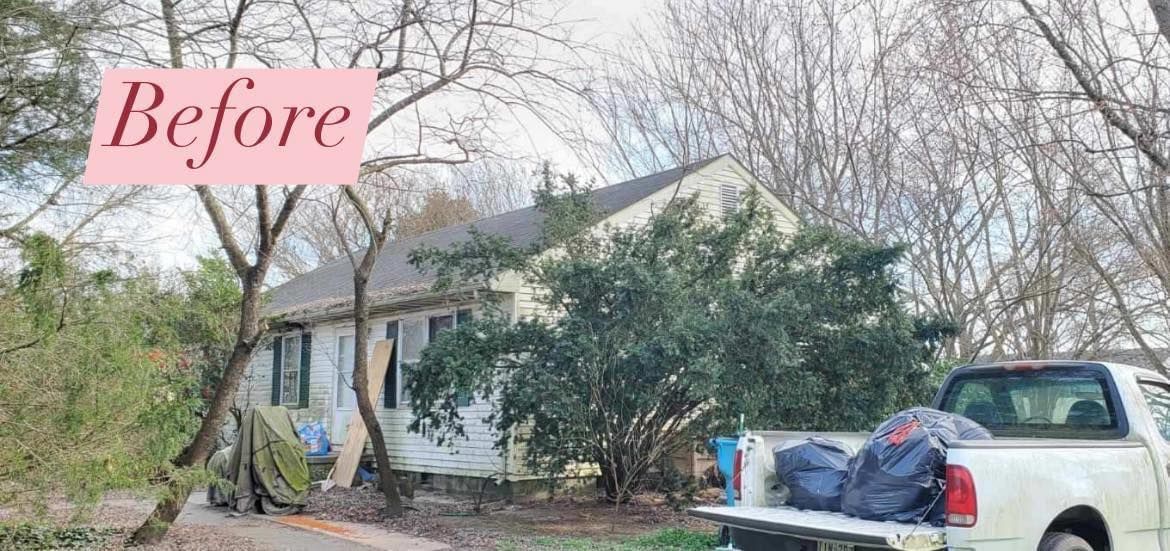 A white truck is parked in front of a house.