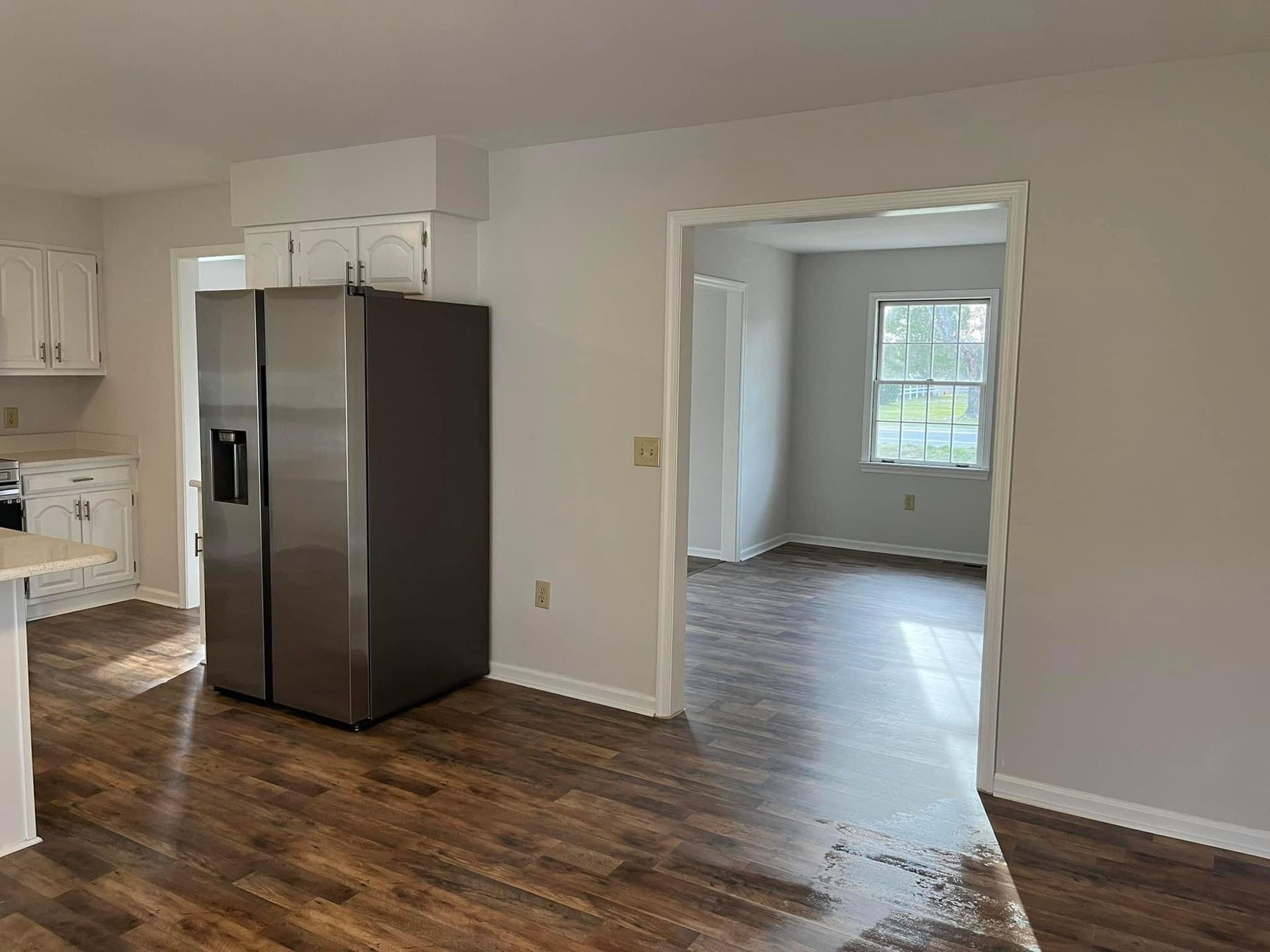 There is a refrigerator in the middle of the room.