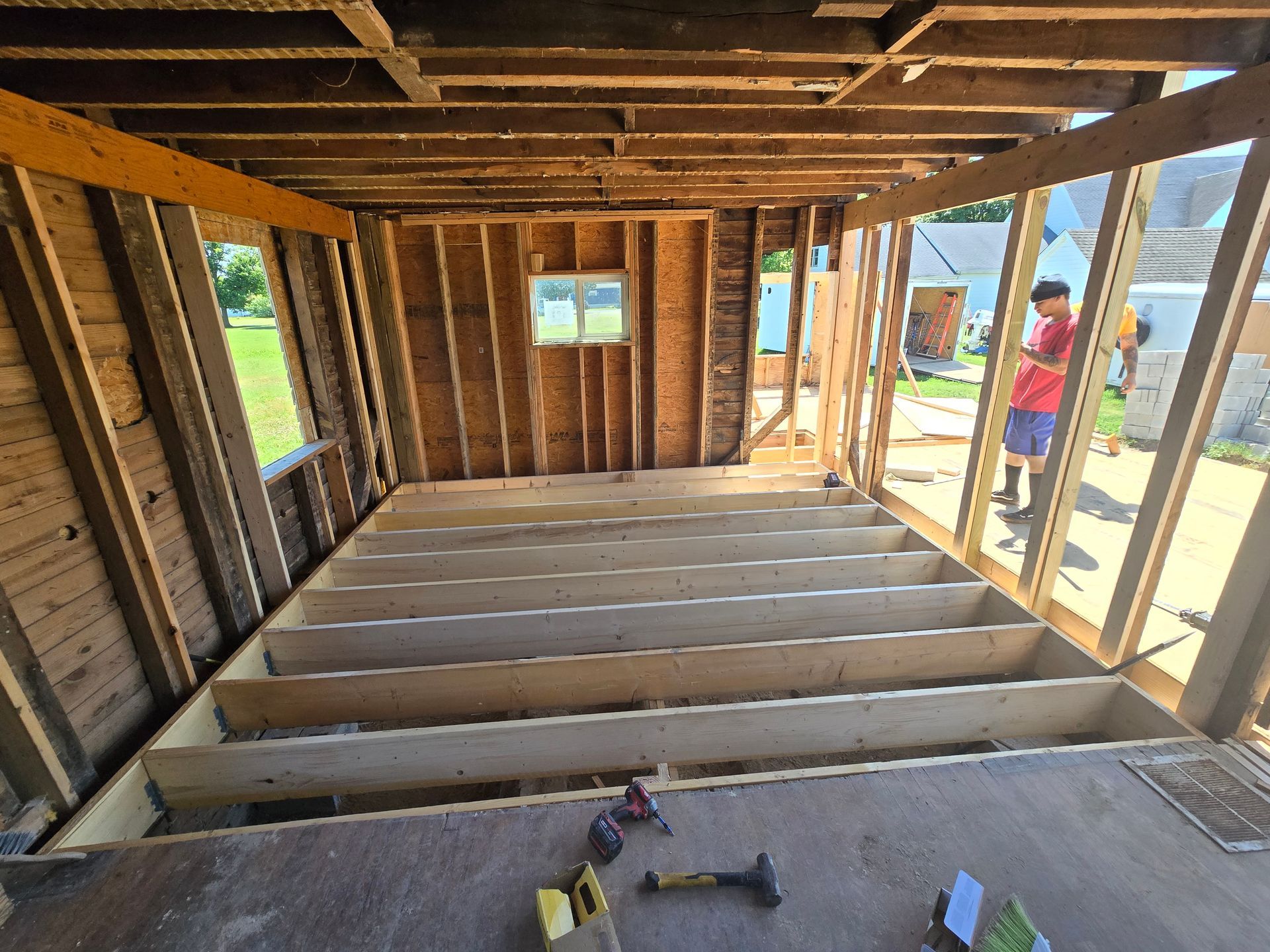 A man is standing in the middle of a building under construction.