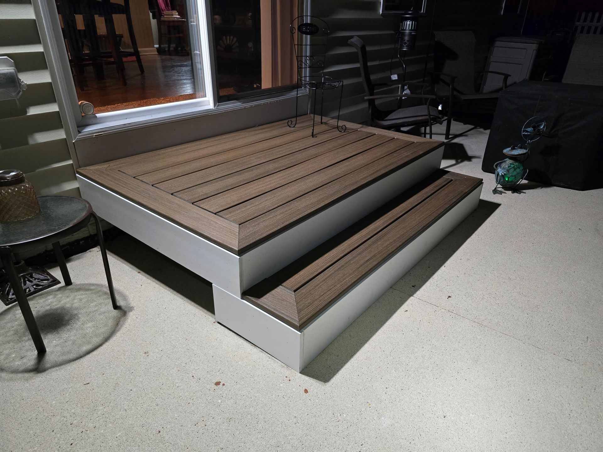 A wooden deck with stairs leading up to it