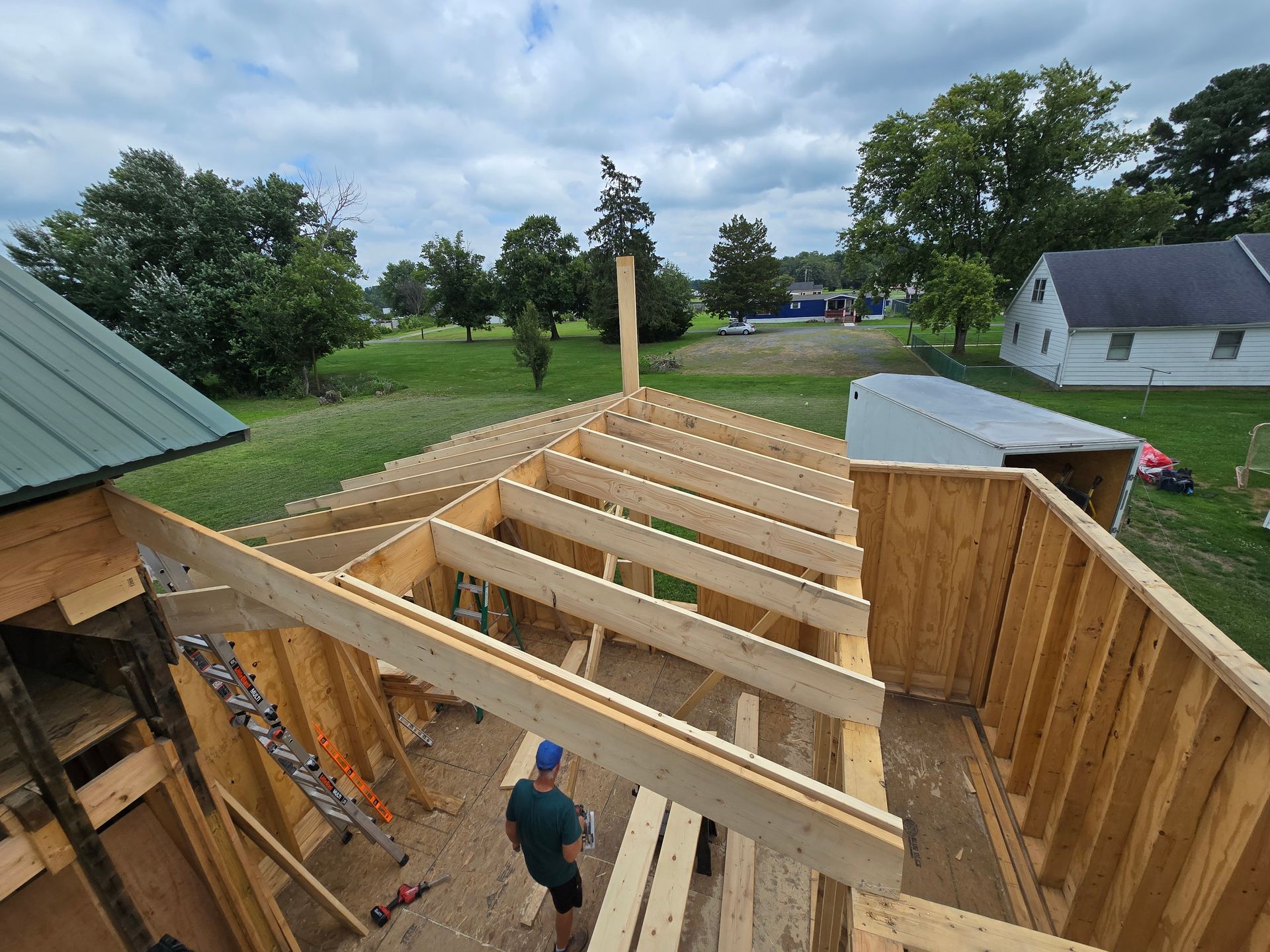 A man is standing in the middle of a wooden structure.
