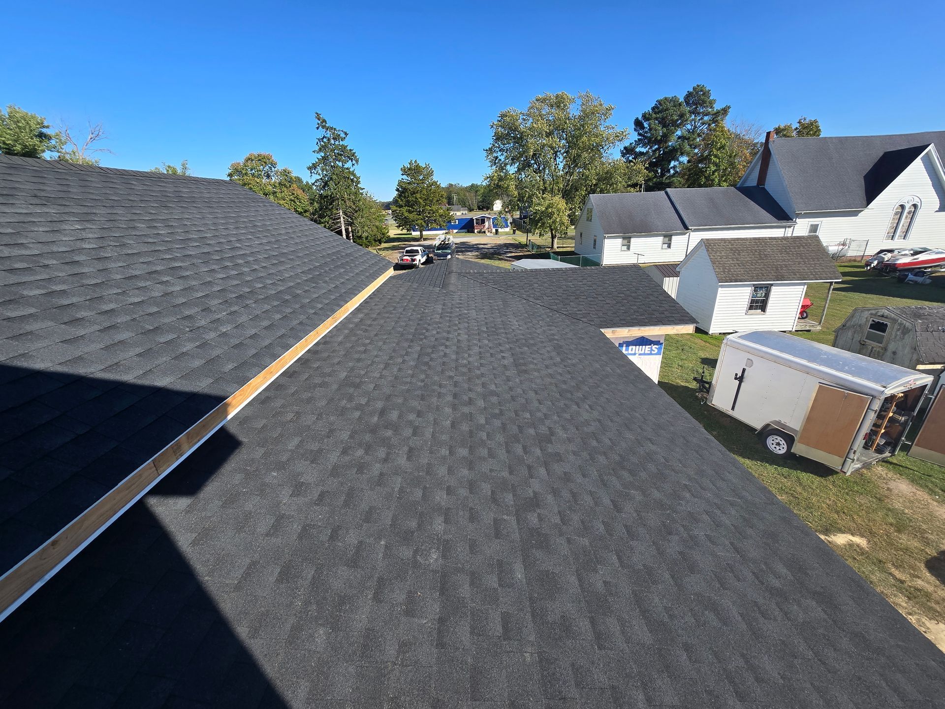 A black roof is being installed on a house.