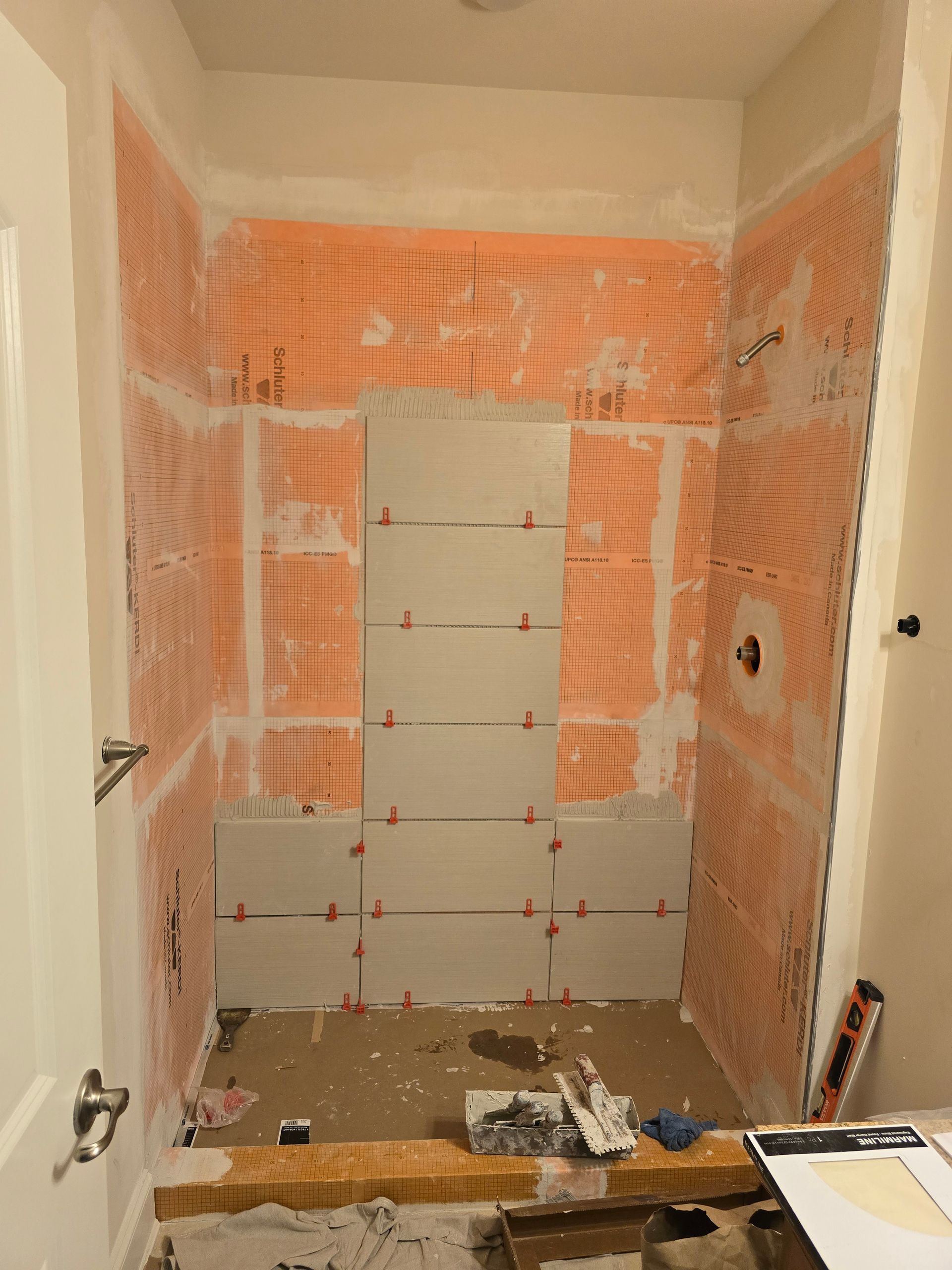 A bathroom is being remodeled with a shower being installed.